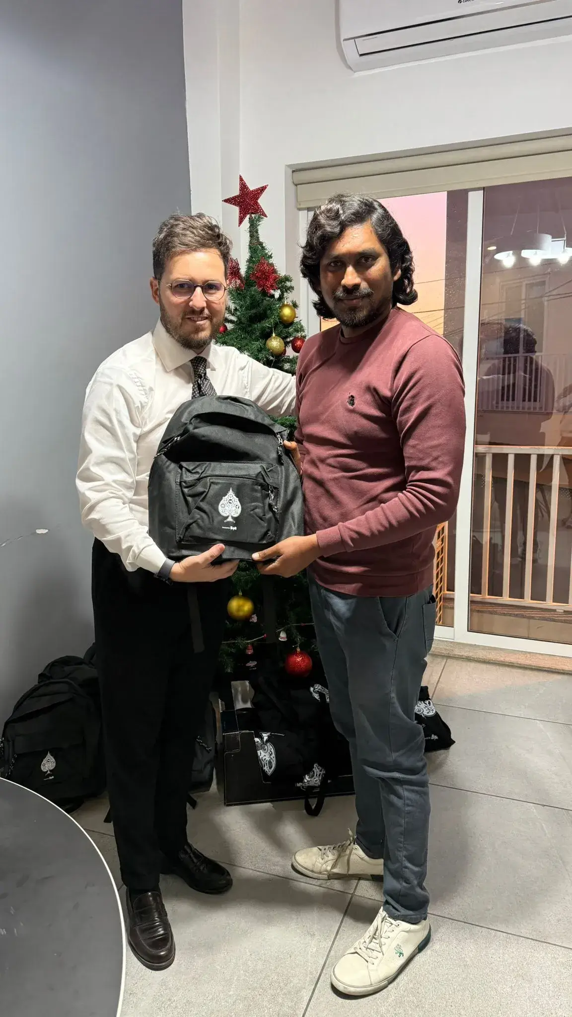 Fabrizio giving a bag to an employee